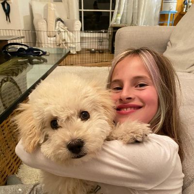 Inga Cadranel's daughter with her pet dog. 